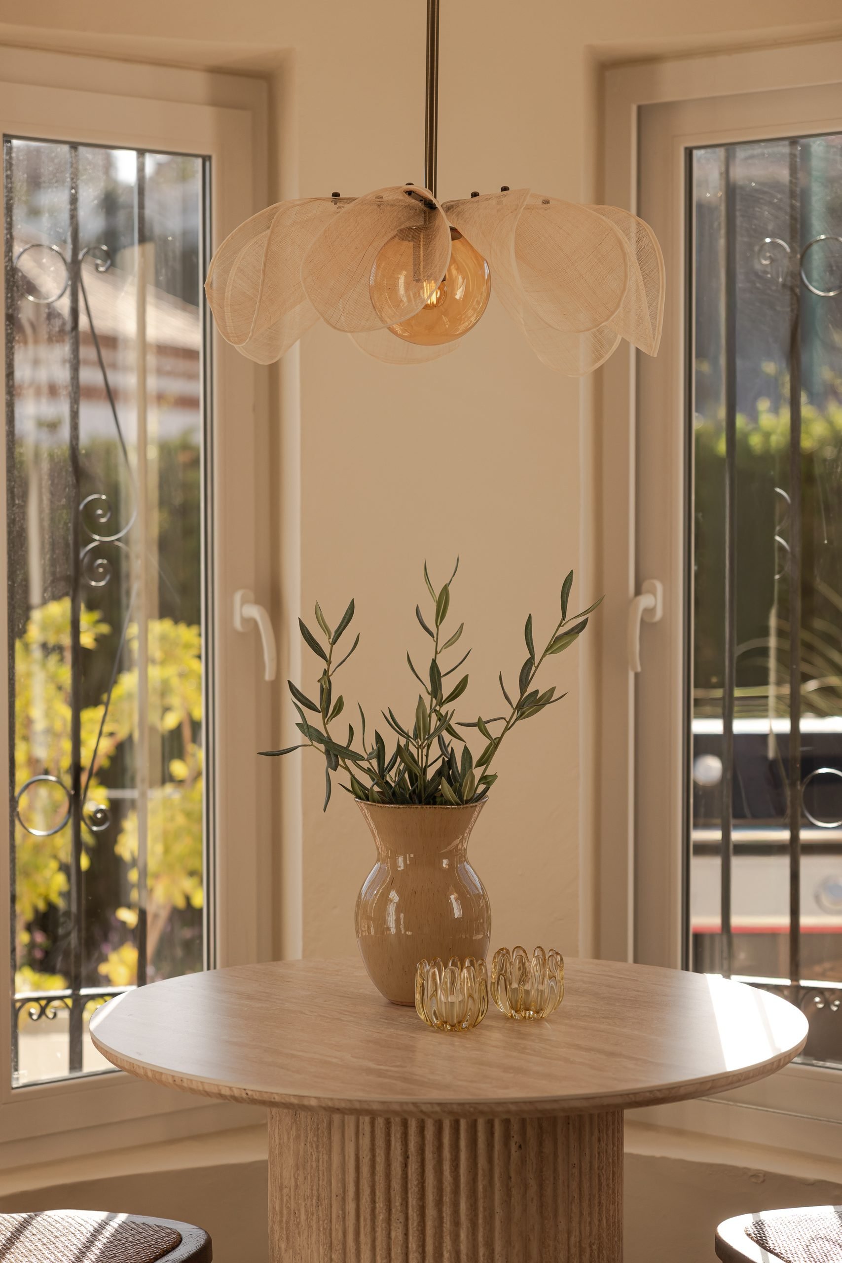 Comedor con lámpara de fibra y ventanales — Deco Caroline, Costa del Sol. Fotografía de Pedro Jaén