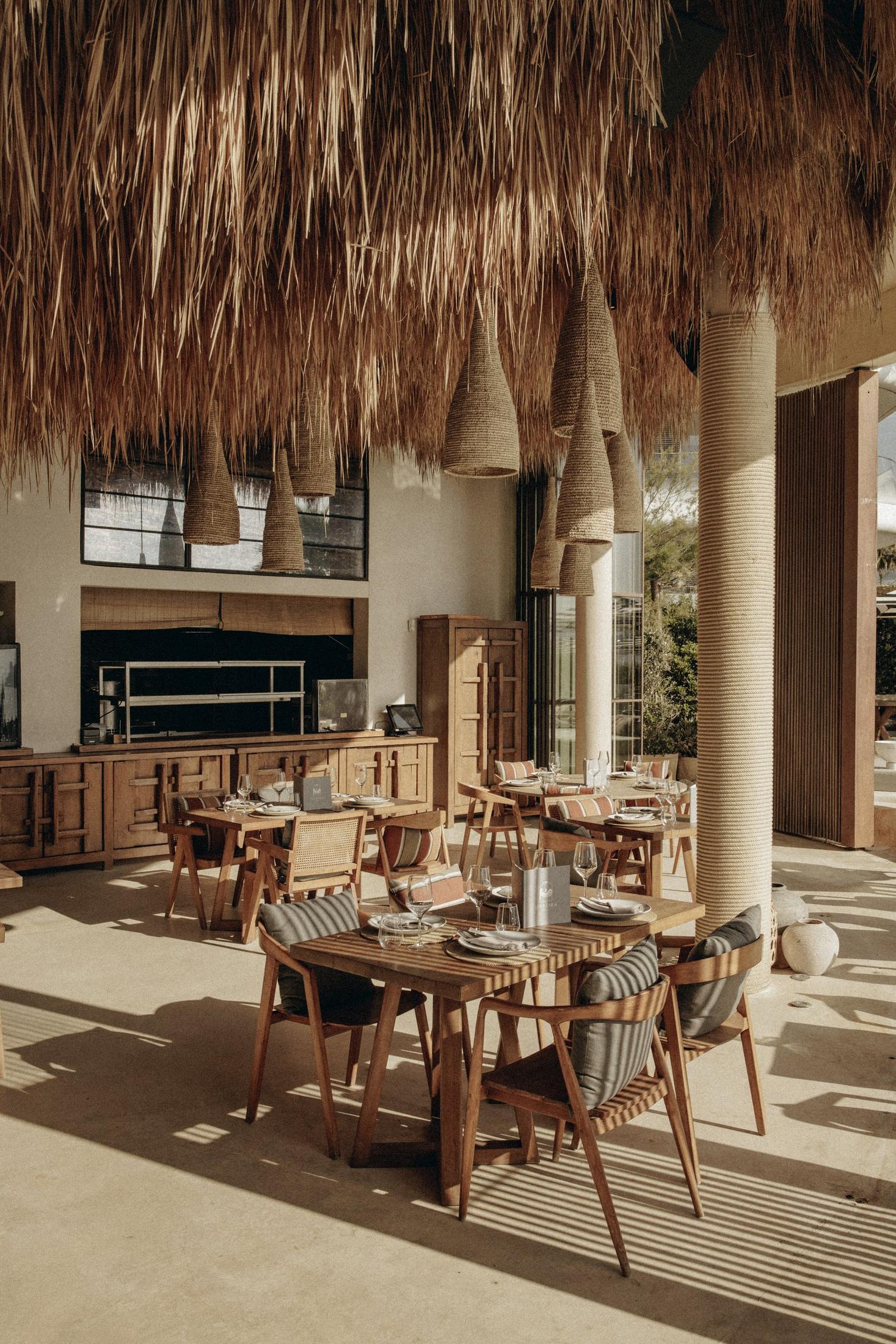 Comedor bajo el techo de palma con lámparas de fibra — Nido, Marbella. Fotografía de Pedro Jaén